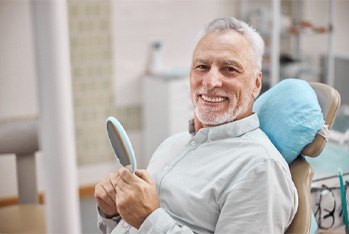 smiling after getting dental implants in Temple