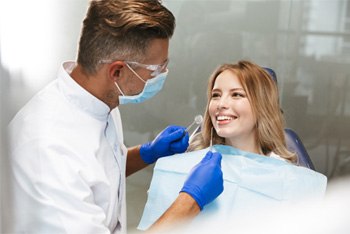 woman talking to her implant dentist in Temple    