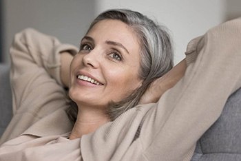 a woman with dentures enjoying her new smile