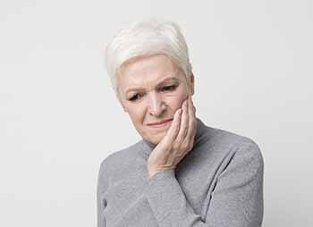 Older woman with a toothache in Temple