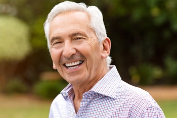 An older man wearing an implant denture in Temple