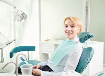 Blonde dental patient sitting in dental chair  
