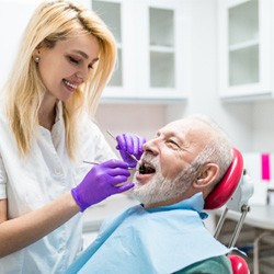 dental hygienist giving a patient a teeth cleaning