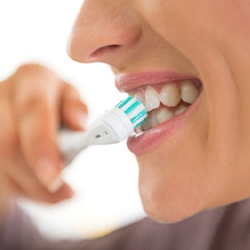 person brushing their teeth