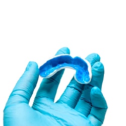 dentist holding mouthguard