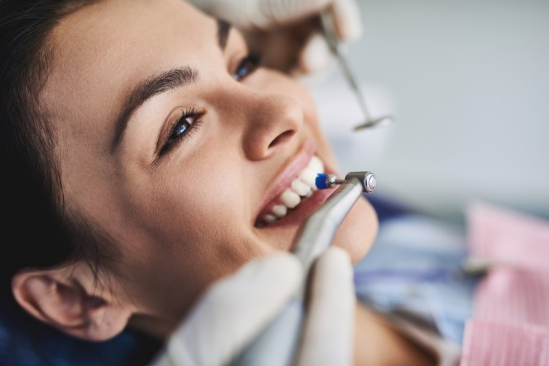 dentist cleaning patient’s teeth during checkup